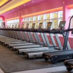 Een vrouw die op een loopband traint in haar woonkamer, perfect voor thuisfitness.